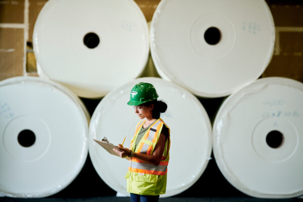 Female contractor holding clip board doing inspections